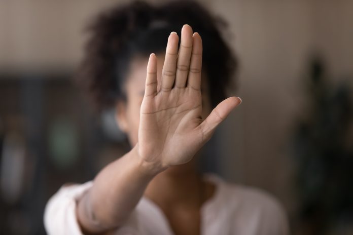 Young African American woman making hand stop denial gesture